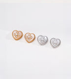 Gold-tone and silver-tone heart stud earrings with mother-of-pearl inlays, cubic zirconia flower accents and beaded borders.