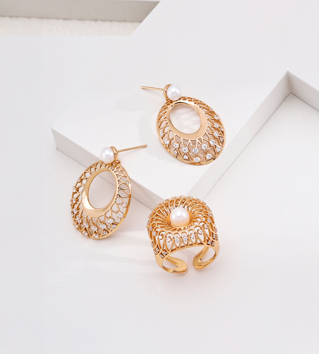 18K gold-plated 925 silver vintage gold oval lace drop earrings with freshwater pearls and cubic zirconia, displayed beside an openwork pearl ring.