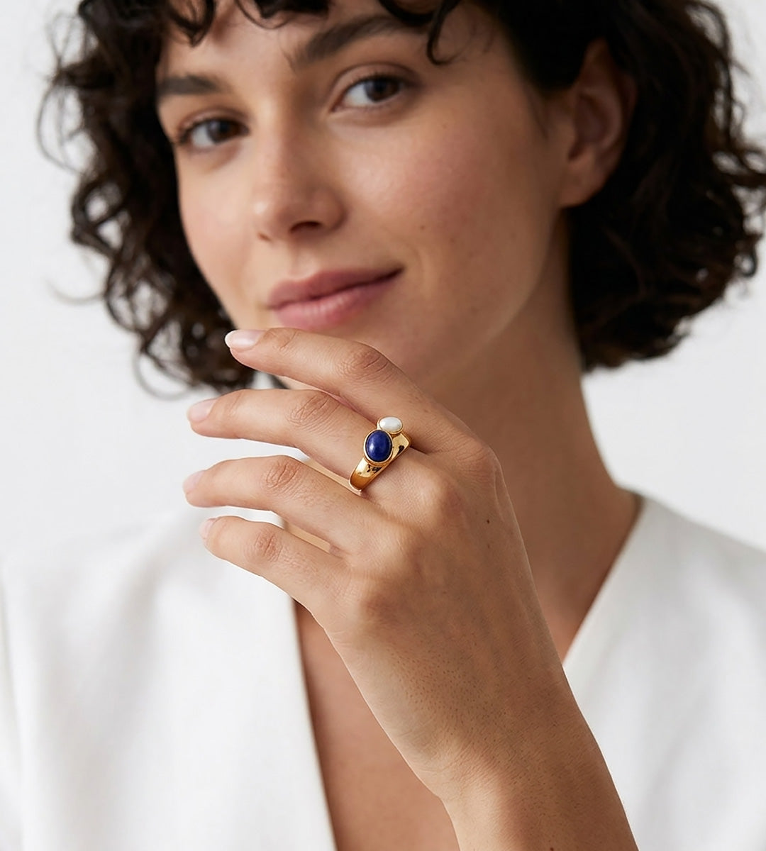 A close-up lifestyle shot of a woman wearing an 18K Gold-Plated S925 Silver Open Ring with Lapis Lazuli and Mother-of-Pearl | BUCKLE Collective