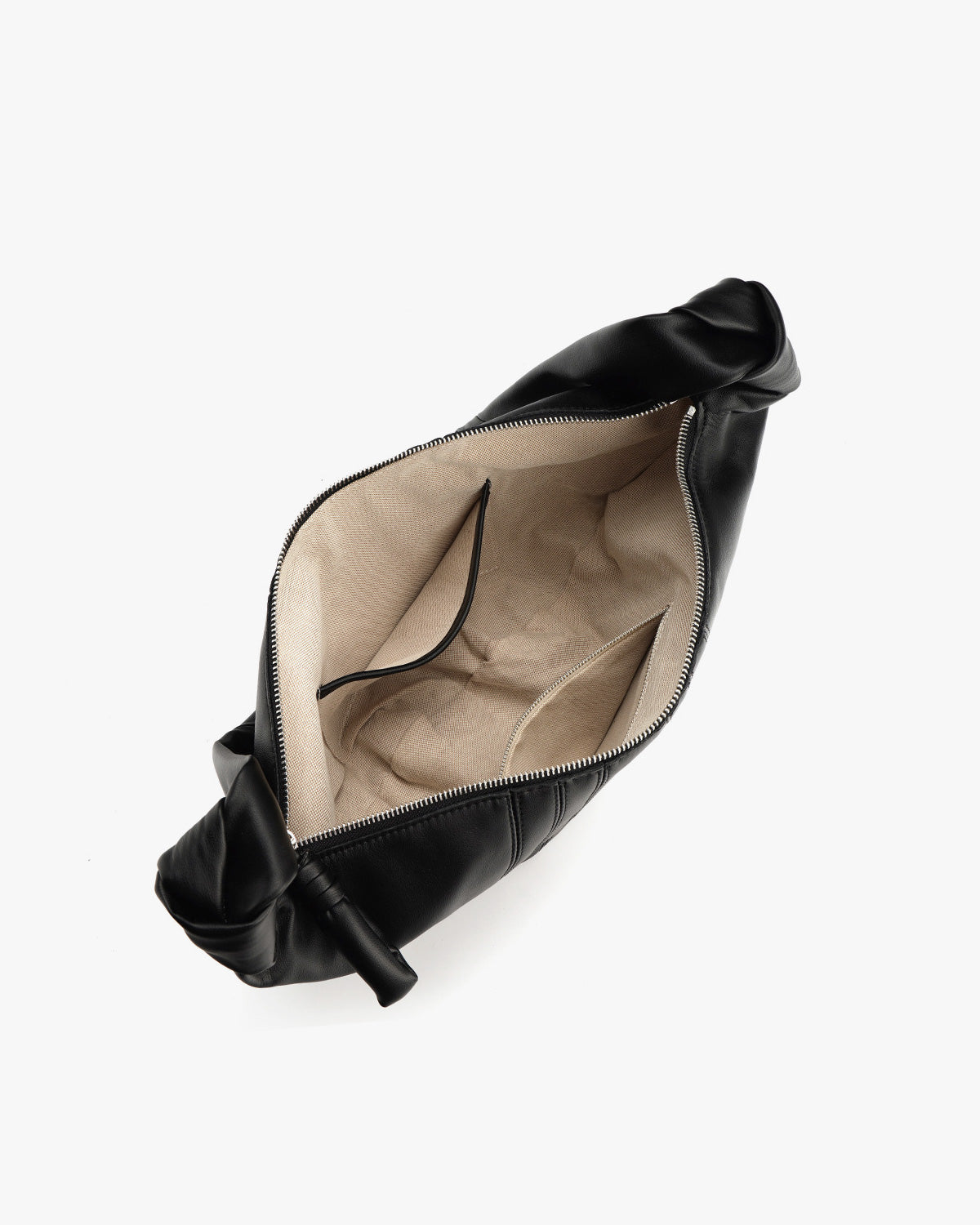 Black leather croissant-shaped bag shown from an overhead angle, open to reveal a beige interior lining, slide-in pocket, and zippered compartment | BUCKLE Collective
