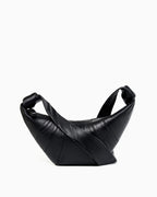 A black leather croissant-shaped crossbody bag by BUCKLE Collective