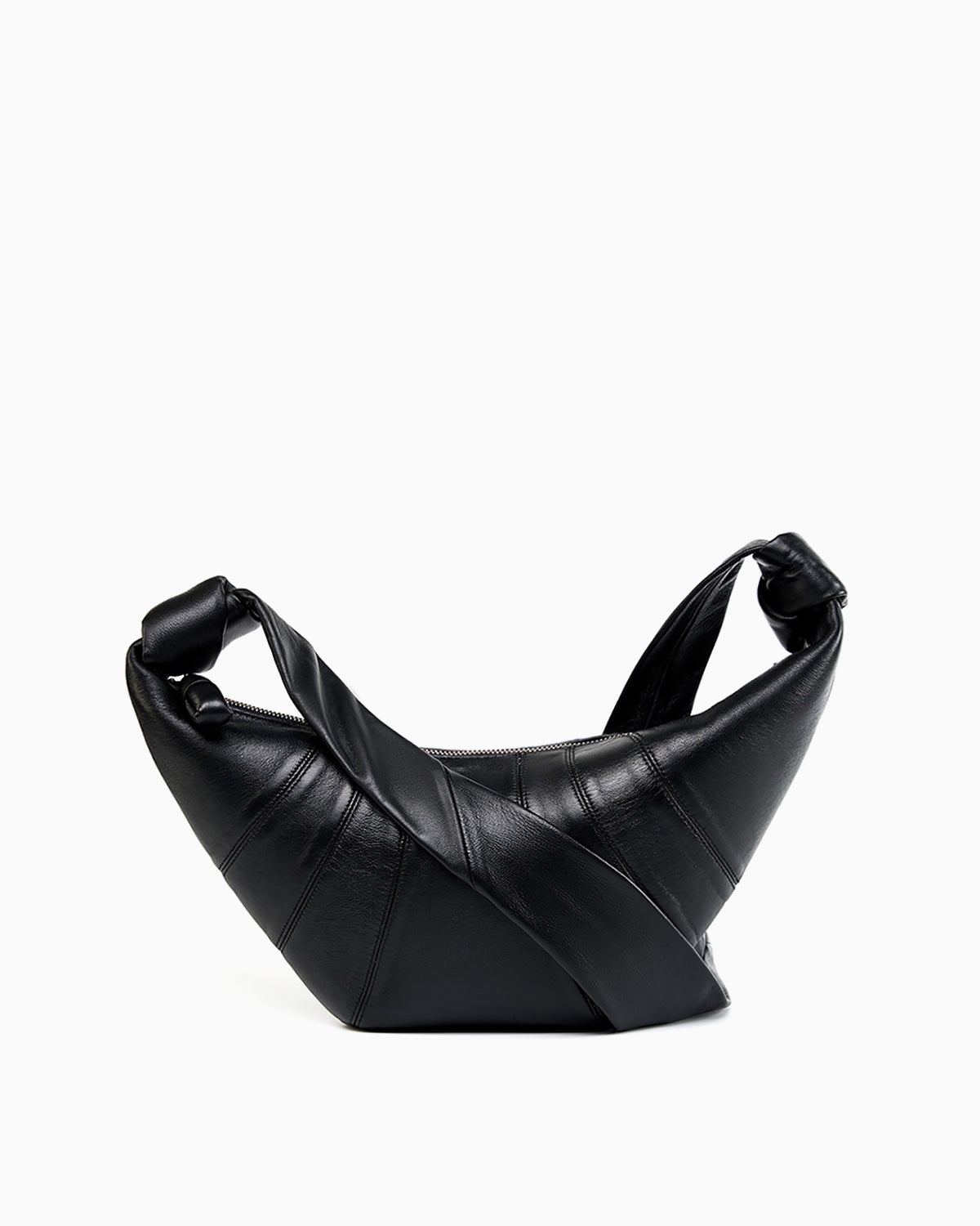 A black leather croissant-shaped crossbody bag by BUCKLE Collective