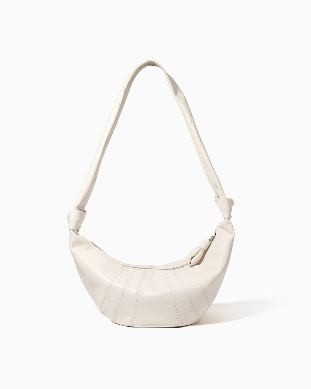 An off-white, large genuine lambskin leather crescent-shaped shoulder bag with a single strap and a zippered top | BUCKLE Collective
