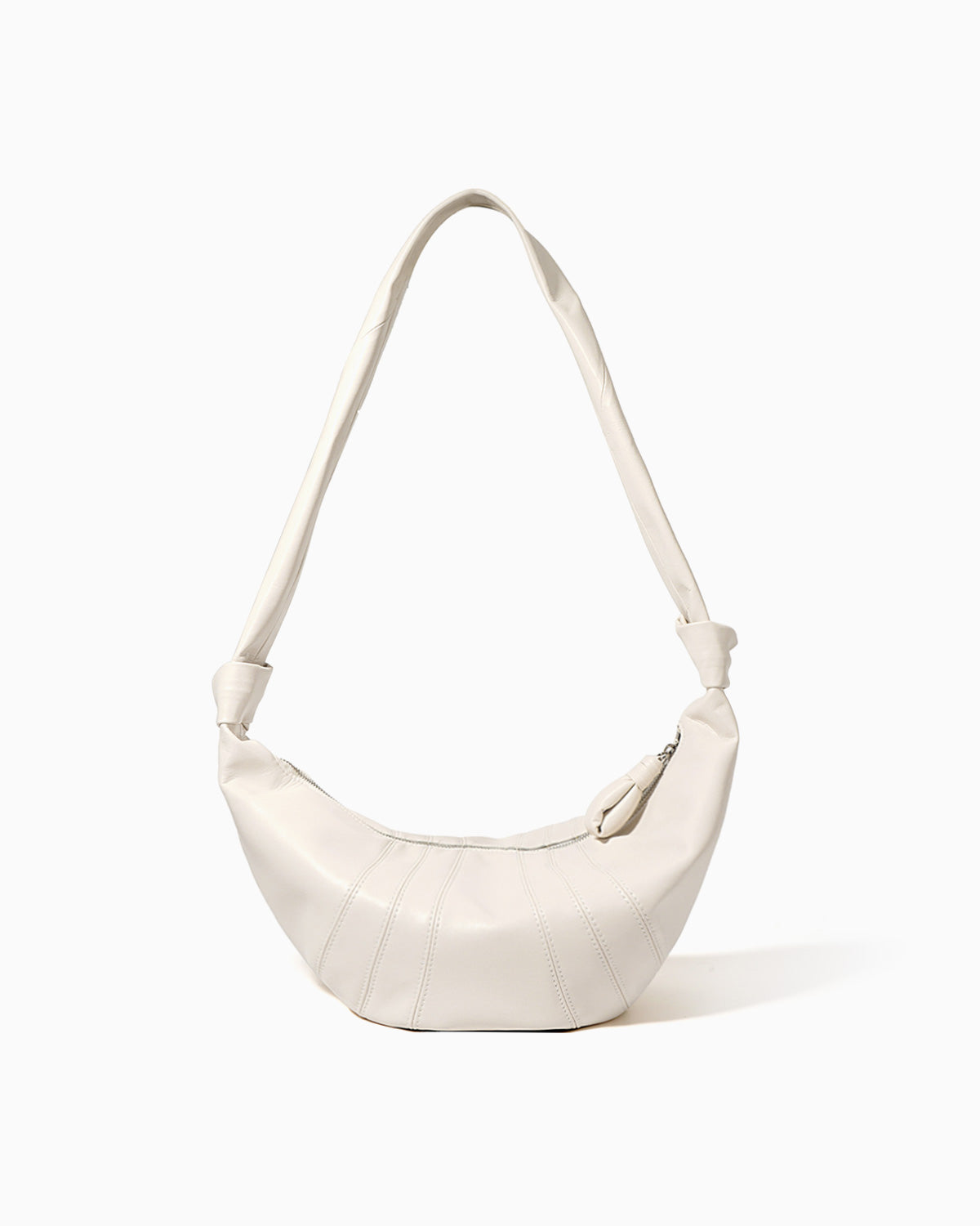 An off-white, large genuine lambskin leather crescent-shaped shoulder bag with a single strap and a zippered top | BUCKLE Collective