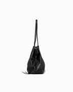 A black leather slouchy pebbled tote bag with double straps, shown from a side profile