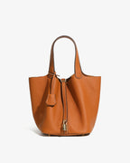 Large Genuine Togo Leather Bucket Bag in Light Brown Color with Gold-toned Lock and Inner Pouch by BUCKLE Collective