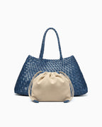 A blue woven leather tote bag with two top handles, shown with a beige drawstring pouch placed in front