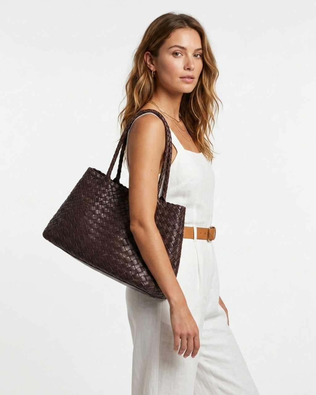 A woman in a stylish summer outfit with Woven Genuine Leather Tote Bag with Removable Pouch, Coffee Color
