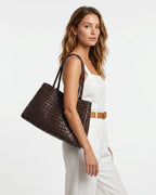 A woman in a stylish summer outfit with Woven Genuine Leather Tote Bag with Removable Pouch, Coffee Color