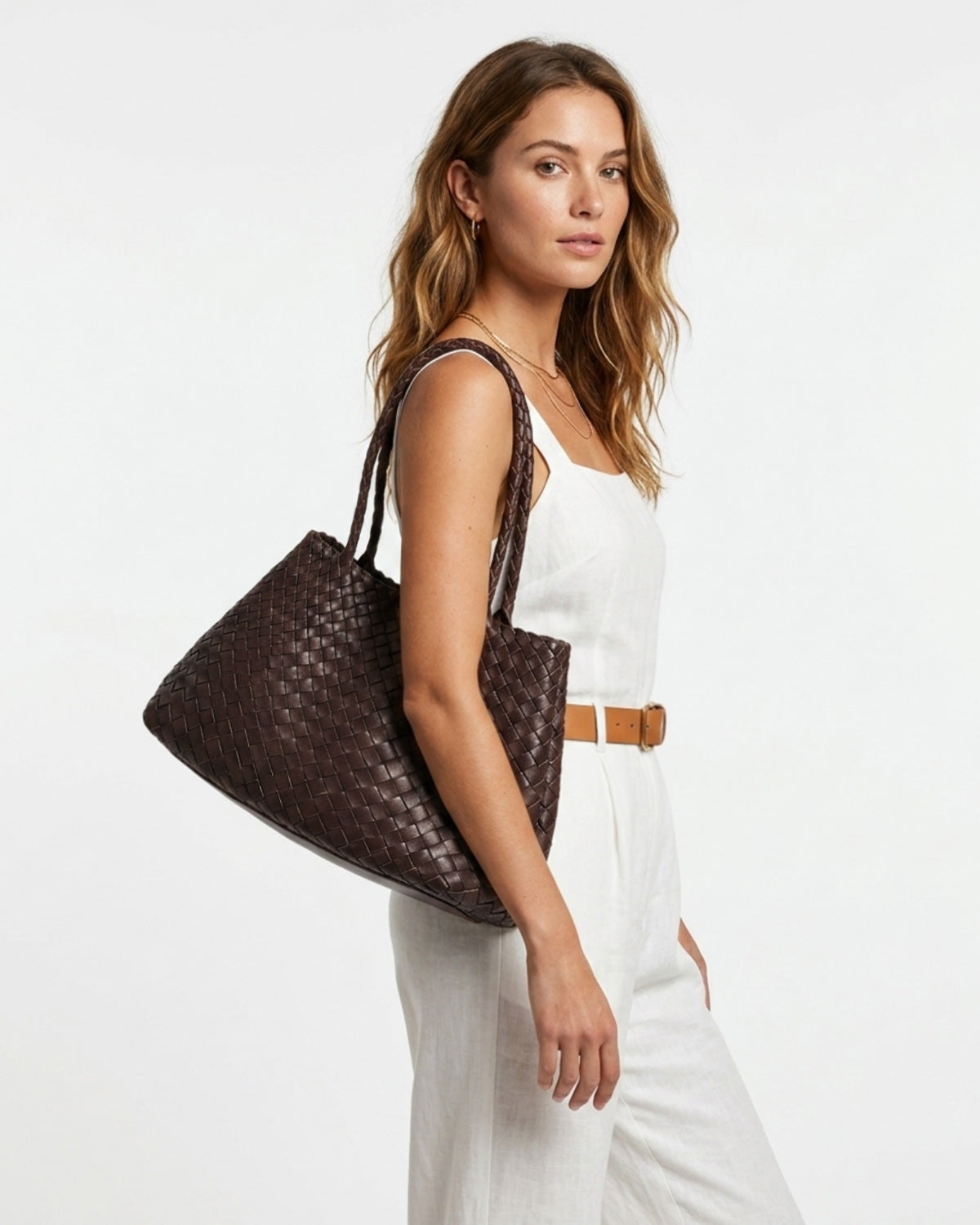 A woman in a stylish summer outfit with Woven Genuine Leather Tote Bag with Removable Pouch, Coffee Color