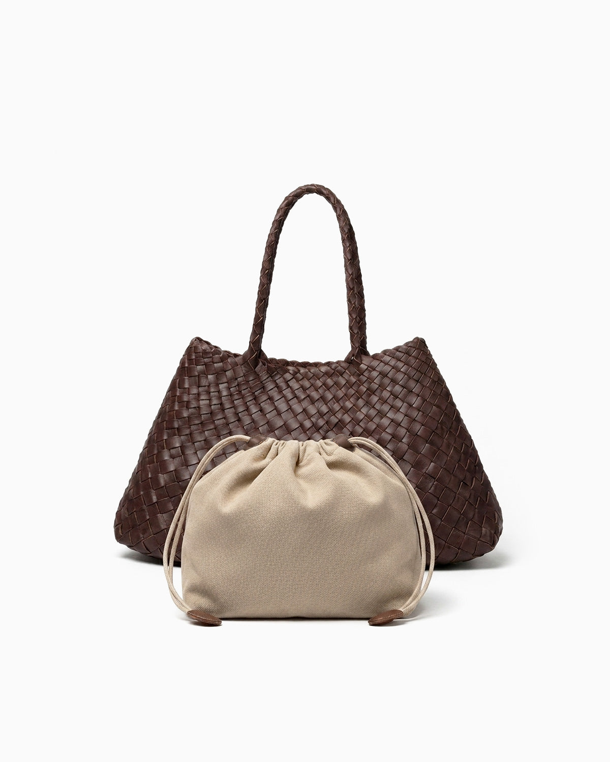 A dark brown woven leather tote bag with dual top handles, shown with a beige drawstring pouch placed in front
