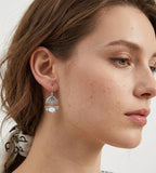 A close-up side profile of a woman wearing a delicate Layered Seashell Mother-of-Pearl Dangle Earrings, 18K White-Gold-Plated S925 Silver | BUCKLE Collective