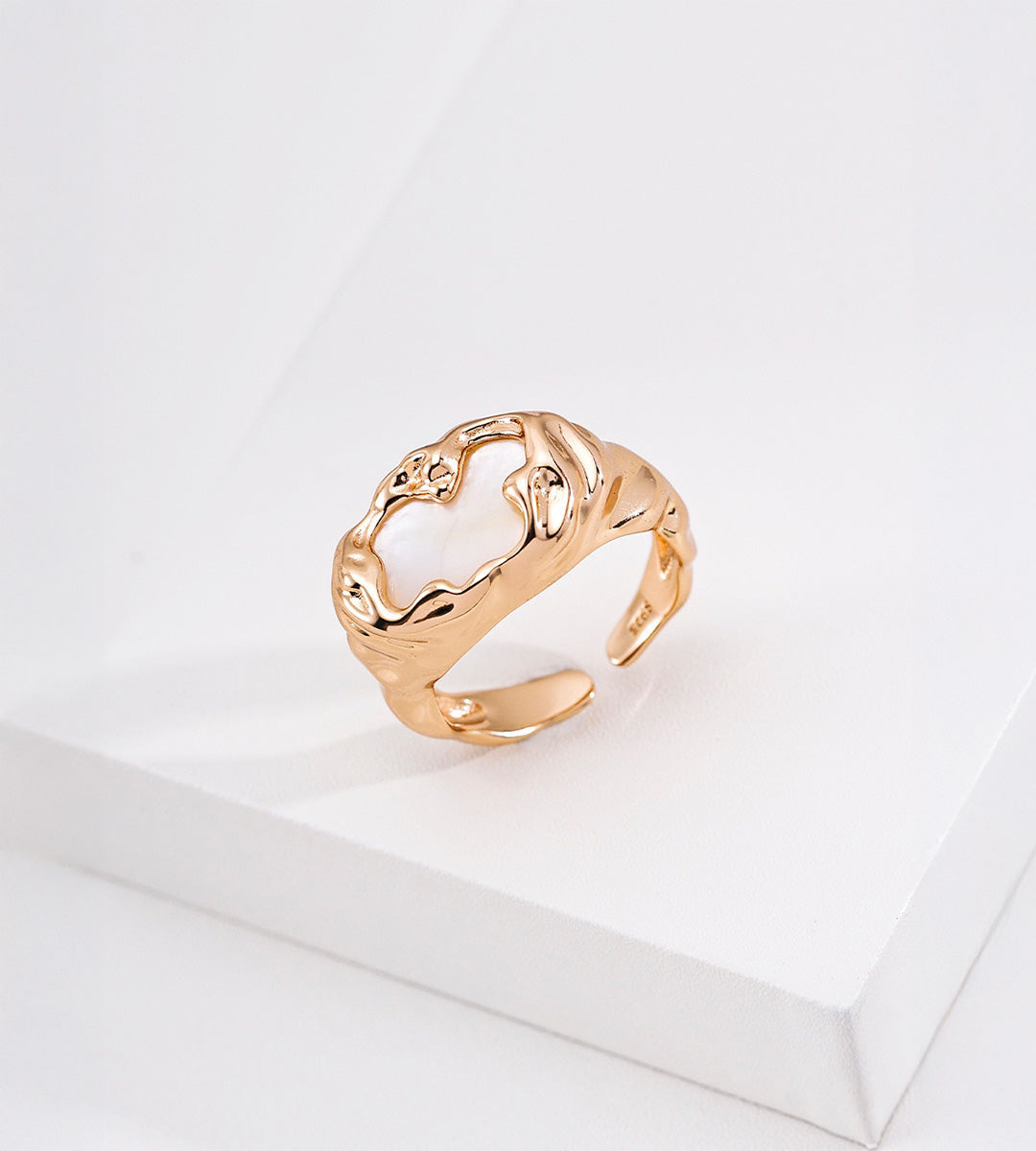 Angled view of an 18K gold-plated S925 silver mother-of-pearl ring, showing its molten-textured frame and open band.