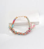 Natural pearl ethnic style braided bracelet flatlay — multicolour mint pink peach teal hemp cord, bamboo gold connectors, freshwater pearls approx. 7mm, adjustable pull-cord, BUCKLE Collective