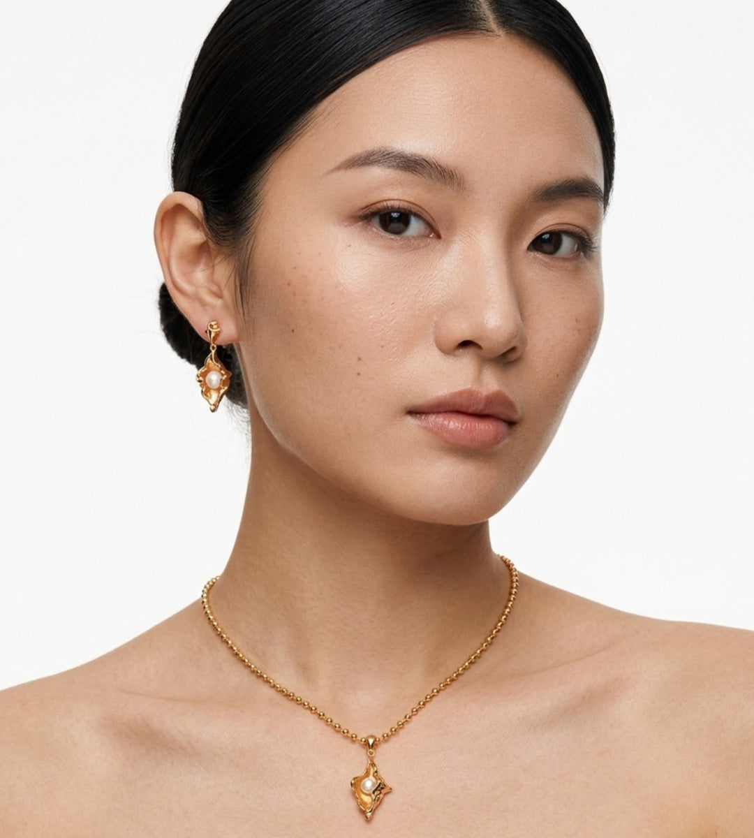 Asian model wearing Ocean’s Whisper Conch Pearl Earrings and Necklace, 18K Gold-Plated S925 over Sterling Silver