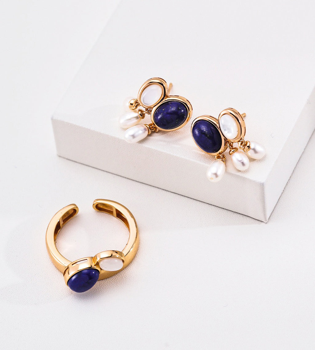 A pair of gold-toned 18K gold-plated on S925 silver drop earrings featuring oval-shaped lapis lazuli and mother-of-pearl, with dangling white natural freshwater alond side with matching ring