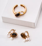 18K Gold-plated jewelry set featuring a curved ring and matching drop earrings, each with an oval tiger's eye gemstone and three dangling white pearl beads