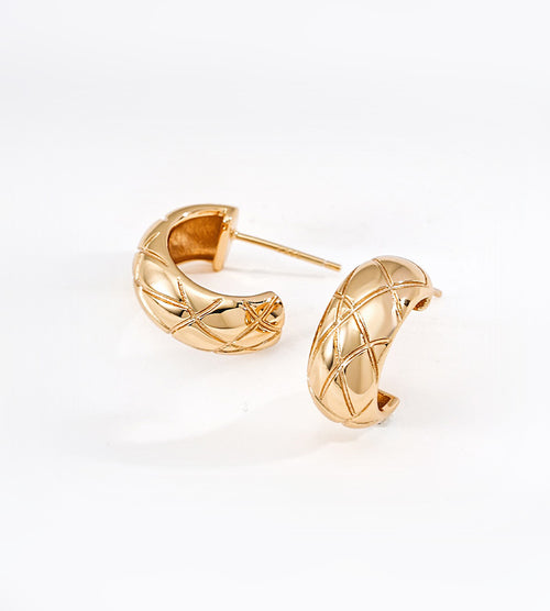 A pair of 18K gold-plated S925 silver huggie hoop earrings with a textured, quilted diamond pattern, displayed on a clean white background.
