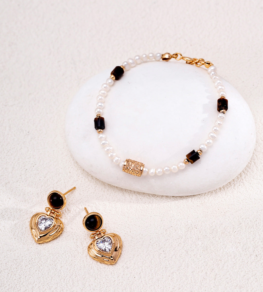 Natural pearl and tiger's eye beaded bracelet in vintage gold styled with tiger's eye heart CZ drop earrings — freshwater pearls, filigree barrel bead, rectangular tiger's eye beads, 18K gold plated S925 silver, BUCKLE Collective