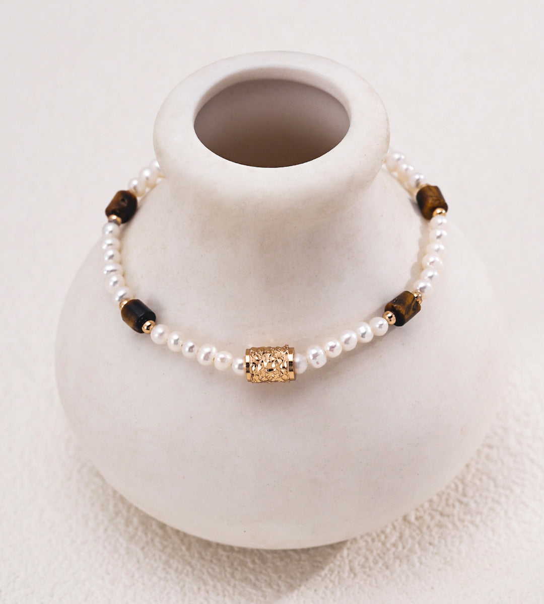 Natural pearl and tiger's eye beaded bracelet in vintage gold styled with tiger's eye heart CZ drop earrings — freshwater pearls, filigree barrel bead, rectangular tiger's eye beads, 18K gold plated S925 silver, BUCKLE Collective