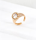 Vintage Gold sculptural open ring with a round cubic zirconia framed by polished bead details, showing the grooved shoulders and open band.