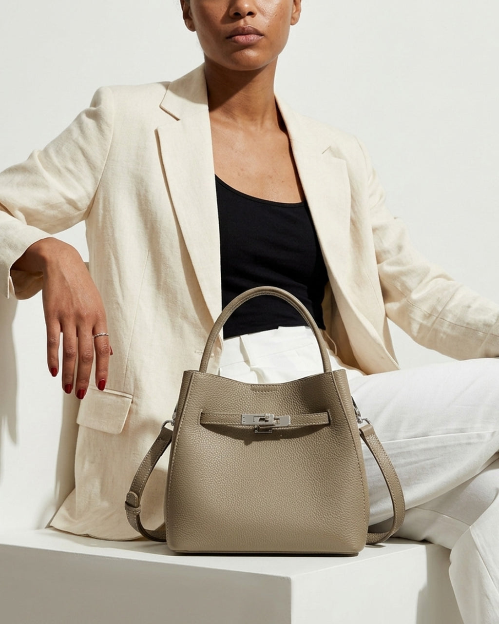 Stylish woman wearing an elegant summer  outfit with a Classic Genuine Leather Bucket Bag in Elephant Gray Color with Detachable Strap & Pouch