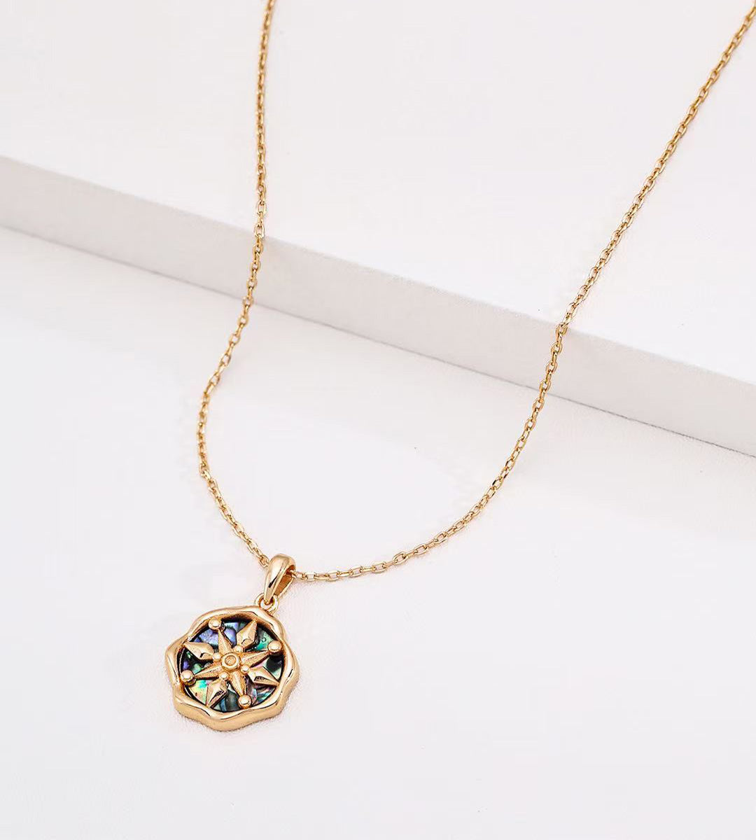 Abalone shell star compass necklace in 18K vintage gold plating — eight-pointed star compass pendant with iridescent abalone shell inlay, wavy octagonal border, adjustable chain, 18K gold plated S925 silver, BUCKLE Collective