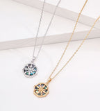 Abalone shell star compass necklace in white gold plating and vintage gold plating — both colourways, eight-pointed compass pendant with iridescent shell inlay, wavy octagonal border, S925 sterling silver, BUCKLE Collective