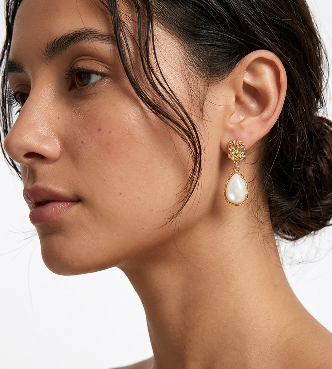 A close-up side profile of a woman wearing 18K Gold-Plated S925 Silver Teardrop Mother-of-Pearl Drop Earrings | BUCKLE Collective