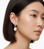 A close-up of a woman's ear wearing 18K White-Gold-Plated S925 Silver Teardrop Mother-of-Pearl Drop Earrings | BUCKLE Collective