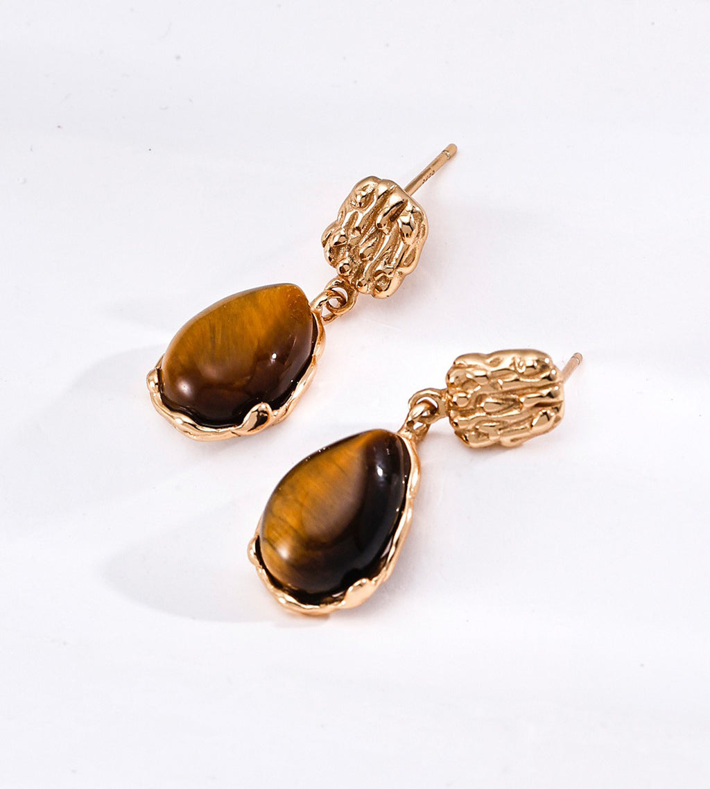 A pair of 18K gold-plated S925 silver drop earrings featuring polished brown tiger's eye stones in textured gold bezel settings | BUCKLE Collective