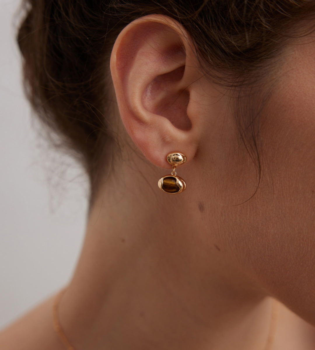 Model wearing The Solstice Tiger's Eye Inlay Drops 18K Gold-Plated on S925 Silver