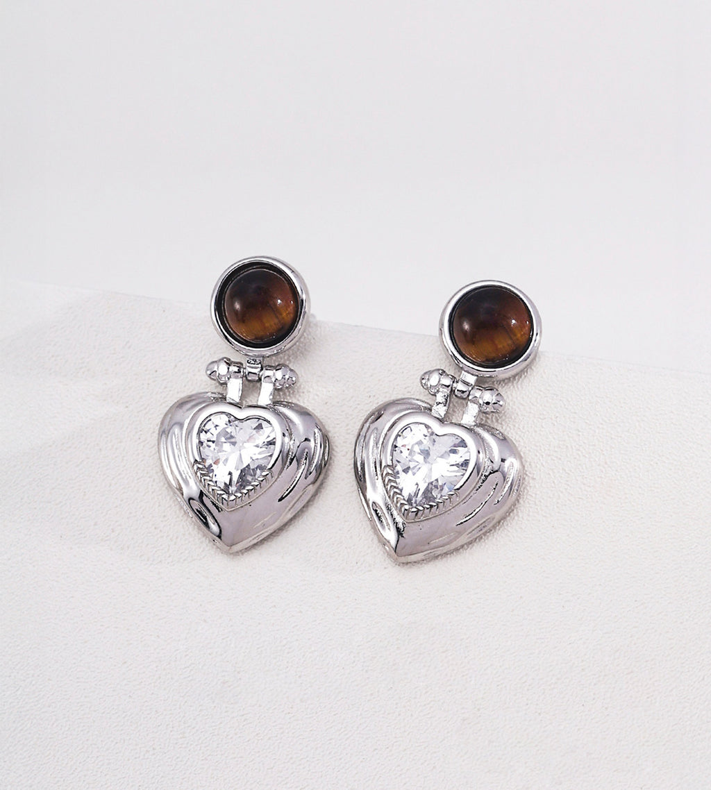Tiger's eye and heart-cut cubic zirconia heart drop earrings in 18K white gold plating — round tiger's eye cabochon stud with puffed gold heart pendant and sparkling CZ centre stone, S925 silver, BUCKLE Collective