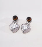 Tiger's eye and heart-cut cubic zirconia heart drop earrings in 18K white gold plating — round tiger's eye cabochon stud with puffed gold heart pendant and sparkling CZ centre stone, S925 silver, BUCKLE Collective