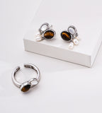 White-Gold-plated jewelry set featuring an open ring and matching drop earrings, each with an oval tiger's eye stone, mother-of-pearl, and three small white natural freshwater pearl drops, 18K Gold-Plated on S925 Sterling Silver | BUCKLE Collective