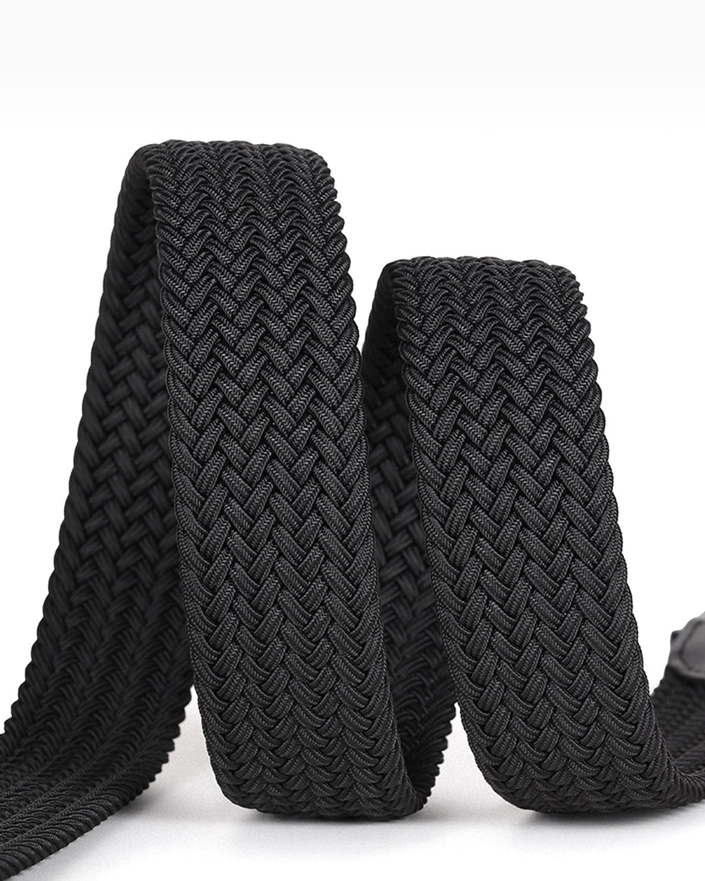 A close-up of a black braided elastic belt with a textured chevron weave, coiled on a white background.