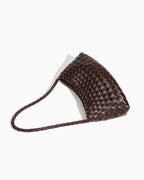 A dark brown woven leather shoulder bag with a braided strap, photographed on a clean white background.