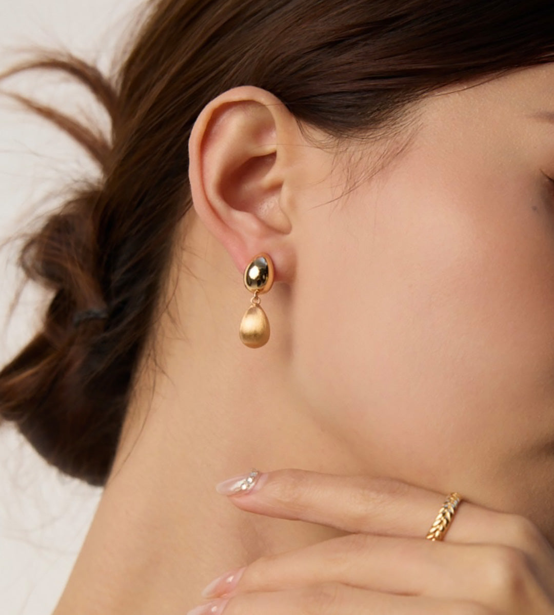 Close-up of a woman wearing 18K Gold Plated S925 Silver Vintage Brushed Teardrop Drop Earrings
