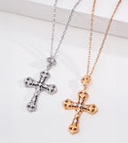 Vintage Gold and White Gold cross necklaces displayed side by side, showing ornate scrollwork and cubic zirconia details.