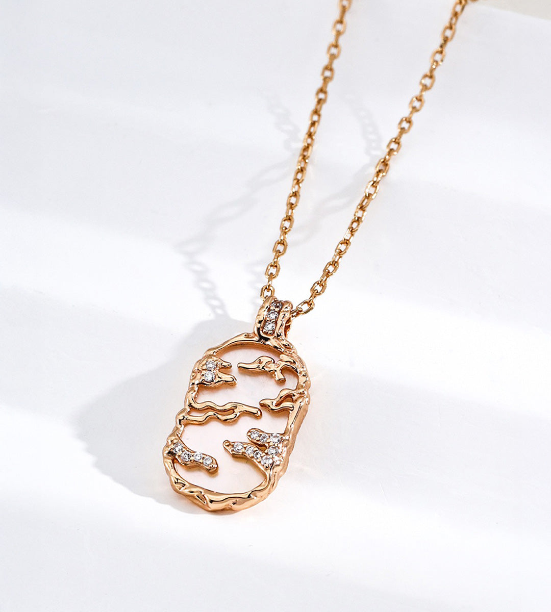 Mother-of-pearl landscape pendant necklace with gold-tone mountain and cloud details, cubic zirconia accents and a fine chain