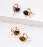 Four gold-plated drop earrings with oval lapis lazuli and tiger's eye stones and three small white pearl drops