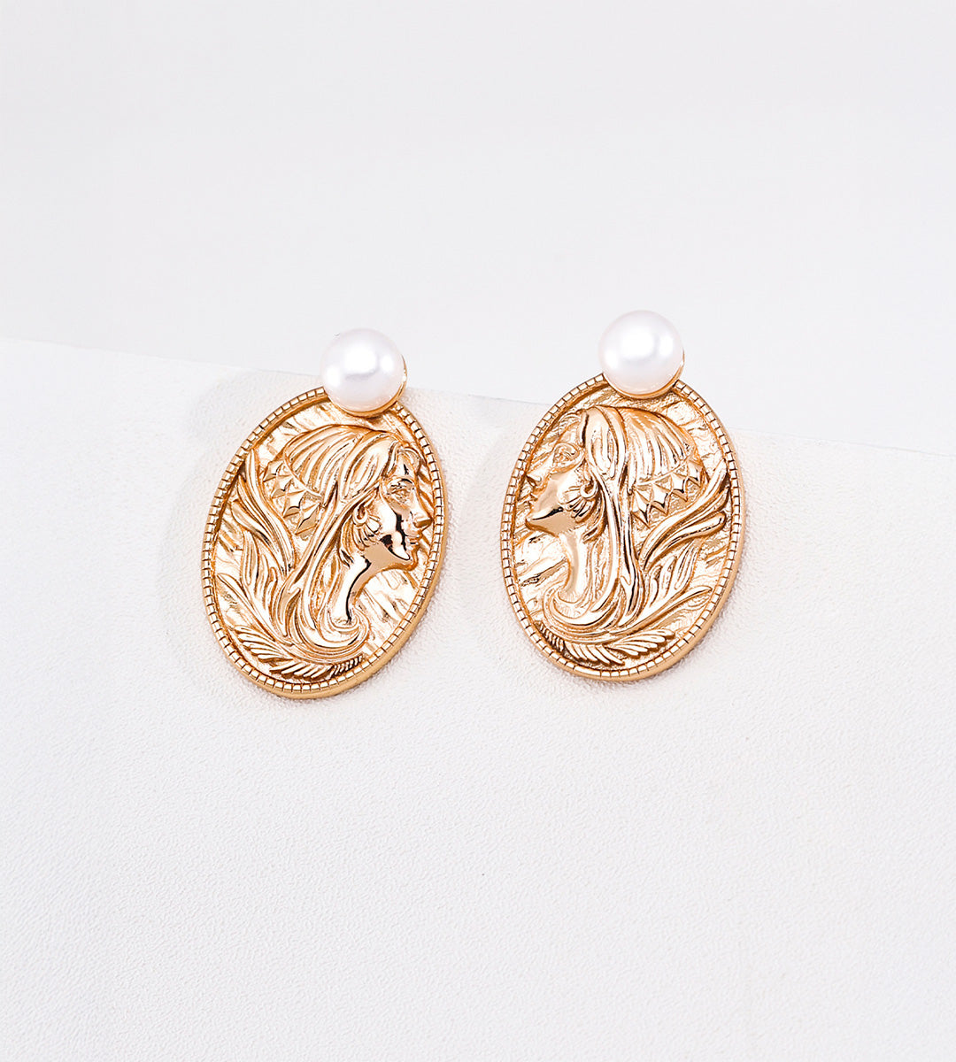 Vintage Gold pearl earrings with embossed oval lady portrait medallions, flowing hair details and finely textured borders.