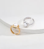 Vintage Gold and silver-tone square pearl rings displayed together, showing their hammered frames and open adjustable bands.