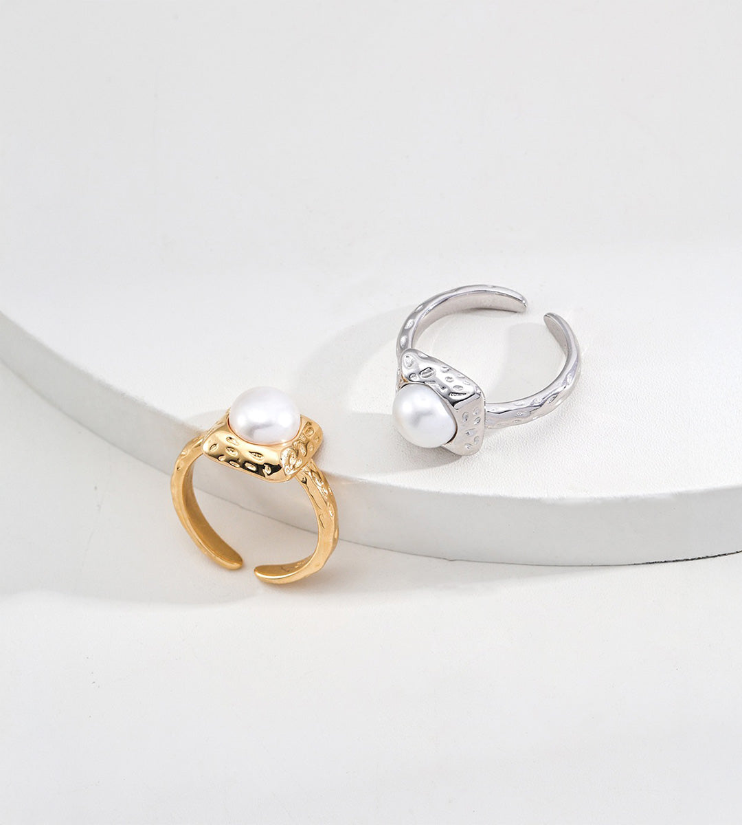 Vintage Gold and silver-tone square pearl rings displayed together, showing their hammered frames and open adjustable bands.