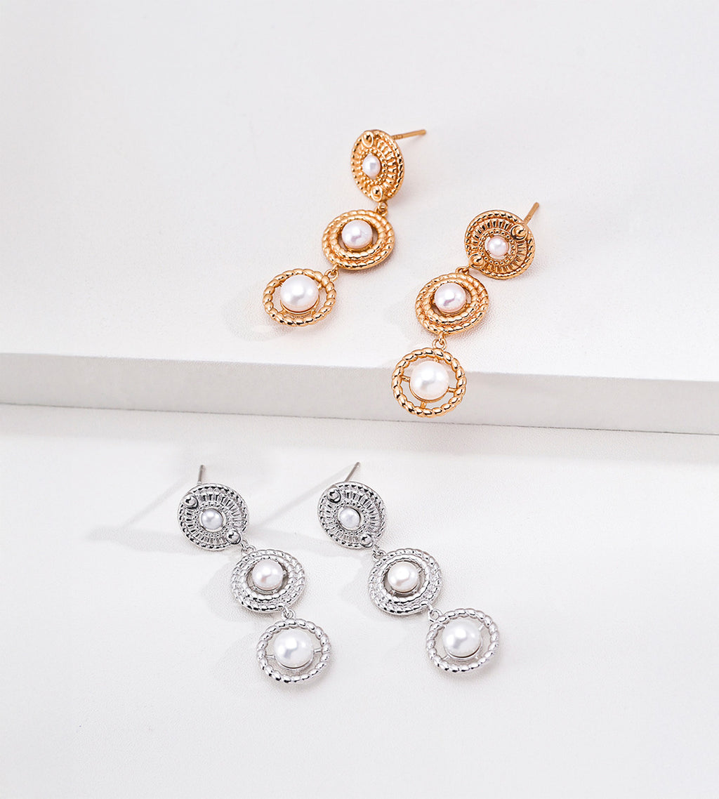 Vintage Gold and silver-tone tiered pearl drop earrings displayed together, showing three linked circular frames with textured borders.