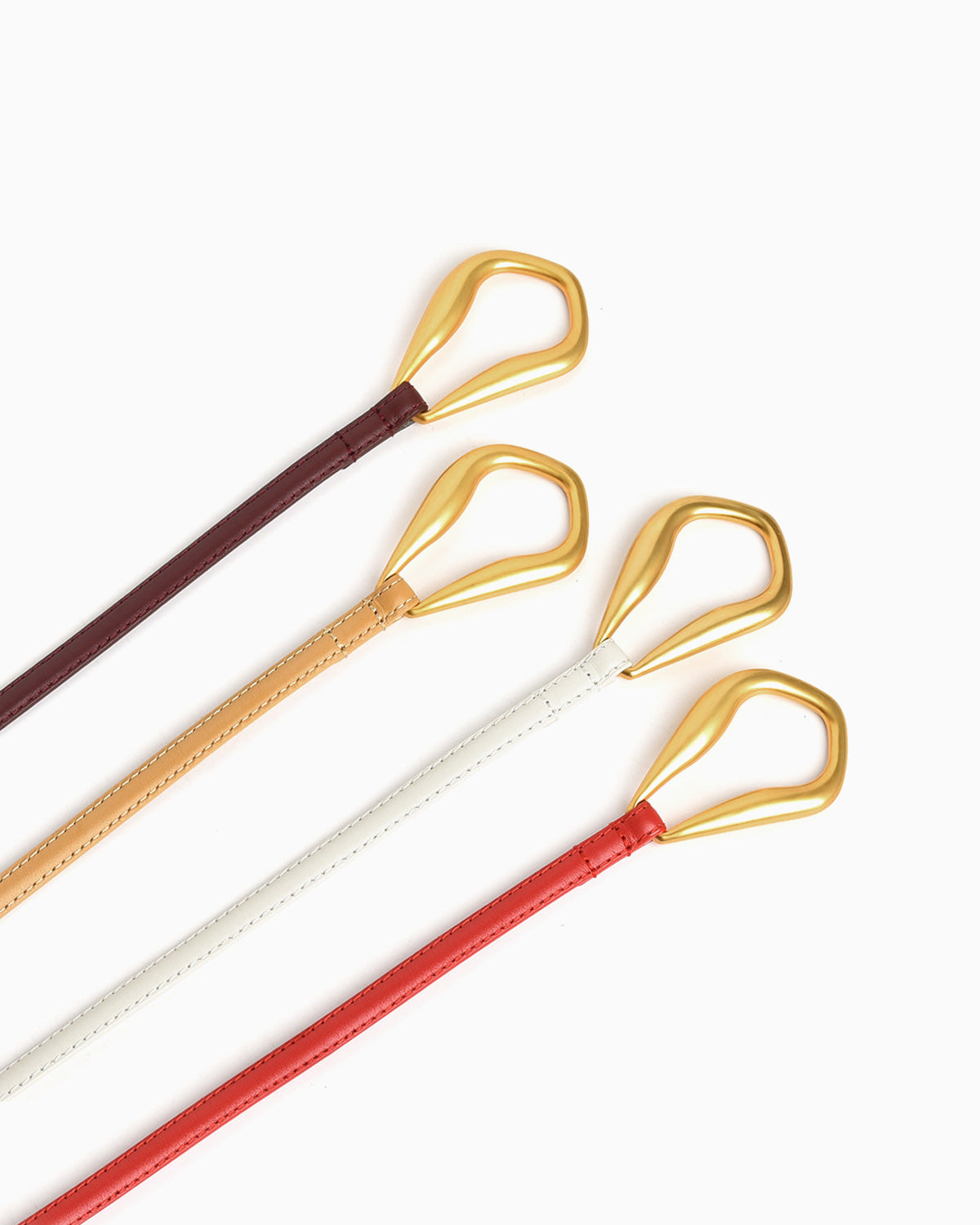 Four Slim Knotted Leather Belts with Gold Loop in burgundy, apricot, white, and red