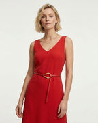 A woman modeling a sleeveless red V-neck dress with a matching Red Slim Knotted Leather Belt with Gold Loop Buckle
