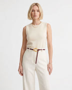 A woman modeling a sleeveless cream knit top paired with matching cream trousers and a Slim Knotted Burgundy Leather Belt with Gold-toned Loop Buckle