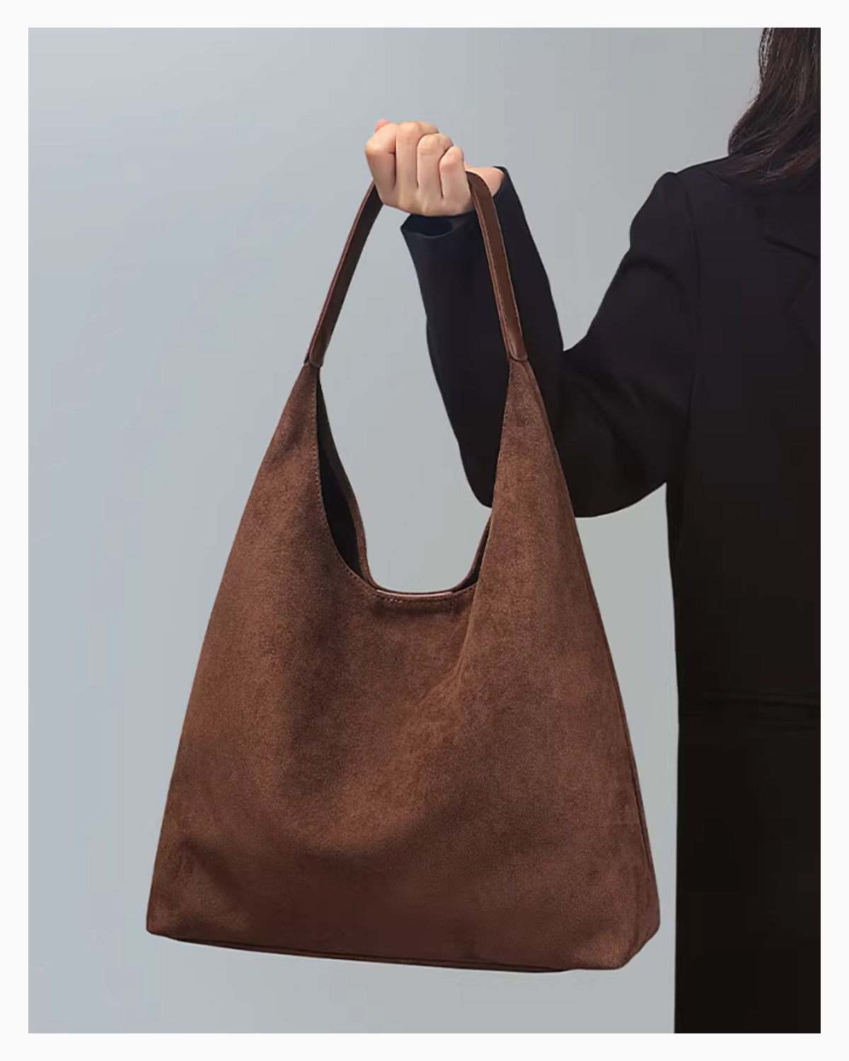 A woman holds a Brown Suede Tote Bag with Vegan Faux leather single shoulder strap