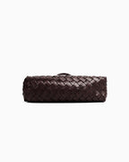A bottom view of a woven leather shoulder bag with a single top handle in Coffee color